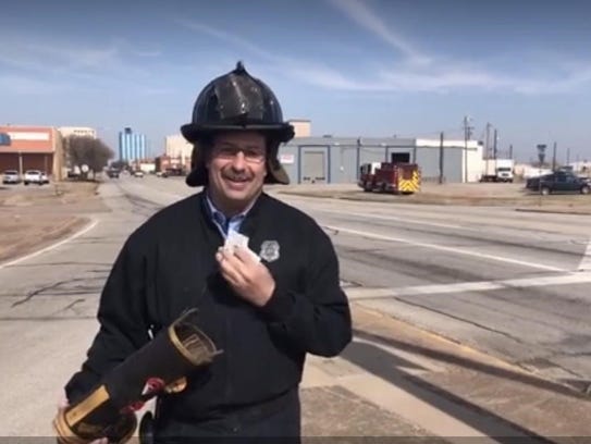 A Wichita Falls firefighter greeted drivers at a downtown