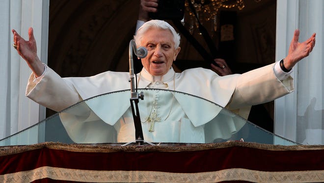 In this Feb. 28, 2013, file photo, Pope Benedict XVI greets the crowd from the window of the Pope's summer residence of Castel Gandolfo, the scenic town where he spent his first post-Vatican days and made his last public blessing as pope. A book of interviews with the Polish Rev. Mieczyslaw Mokrzycki, “Secretary of Two Popes,” released May 2017, has offered some insight into the daily life at the Vatican with John Paul and his German-born successor, Benedict XVI.