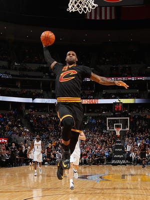 DLeBron James goes up for a dunk at Pepsi Center.