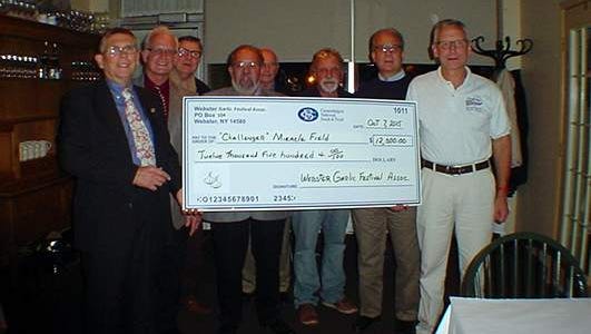 (L-R) Webster Garlic Festival Association board members Rich Comins, Gary Lazzaro, Roger Awe, Bill Freeman, Harry Clauss, Whitey Proietti, Robert Anderson and Ron Kampff of “Challenger” Miracle Field
