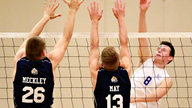 Spring Grove's Noah Wilson, right, hits the ball across the net while West York's Kenton Meckley, left, and Jacob May defend during volleyball action at Spring Grove Area High School in Spring Grove, Thursday, May 18, 2017. Dawn J. Sagert photo