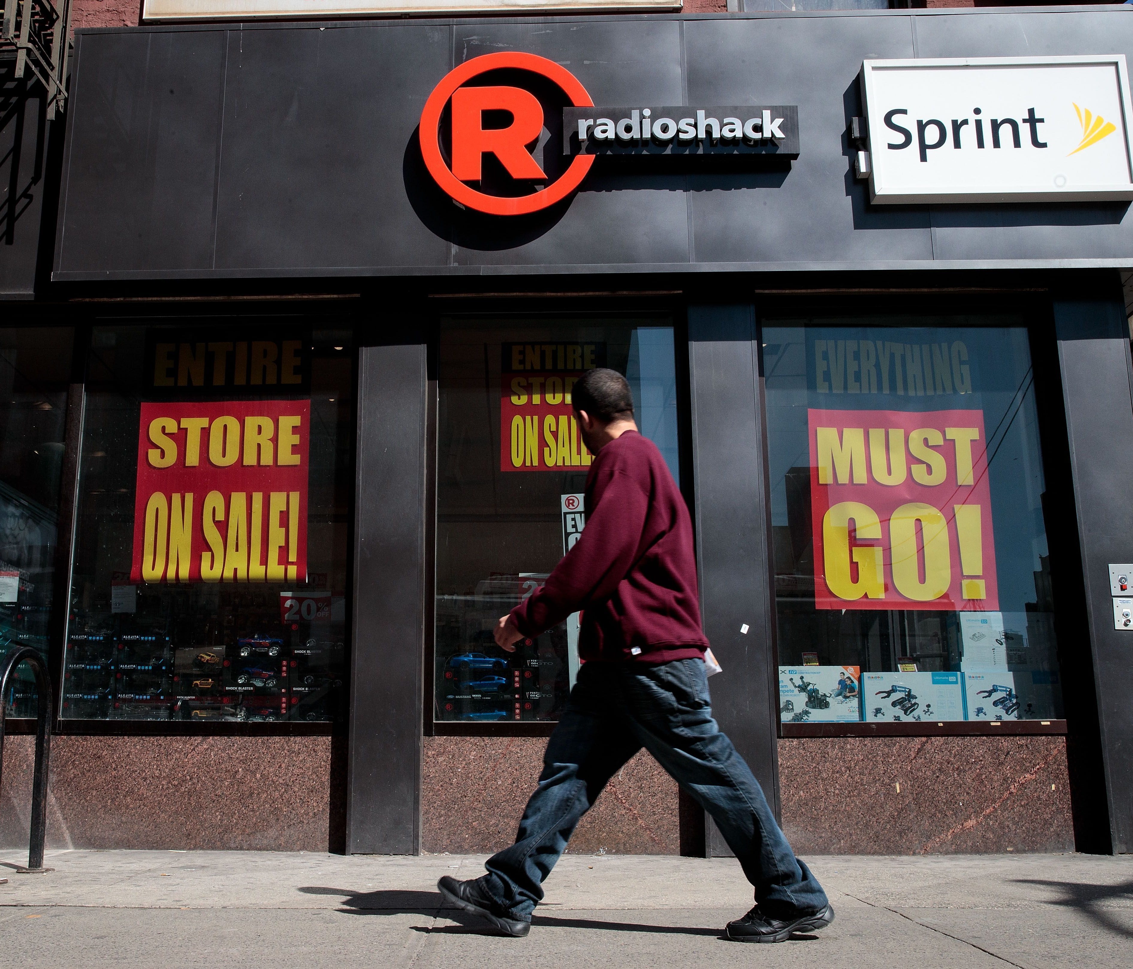 A man walks past a RadioShack storefront in the Chelsea neighborhood of New York