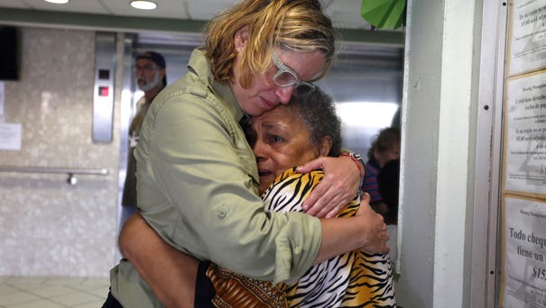 San Juan's Mayor Carmen Yulin Cruz, left, hugs a...