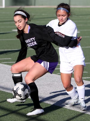 Abilene Wylie's Gracie McCaslin, left, holds off Wichita Falls High School's Marley Fleisher Thursday, Jan. 11, 2018, at Memorial Stadium. The Bulldogs defeated the Coyotes 2-0.