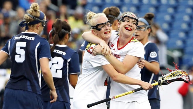 Maryland attack Megan Whittle (23) celebrates a goal with Caroline Steele (11) against Penn State during the second half of their NCAA semifinal game at Gillette Stadium.