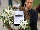 The Rev. Jason Chen carries a wreath across the University of Iowa campus on Nov. 1, 2001. Each Nov. 1 the Association of Campus Ministers has placed a wreath on the T. Ann Cleary Walkway, named for one of those shot by Gang Lu.