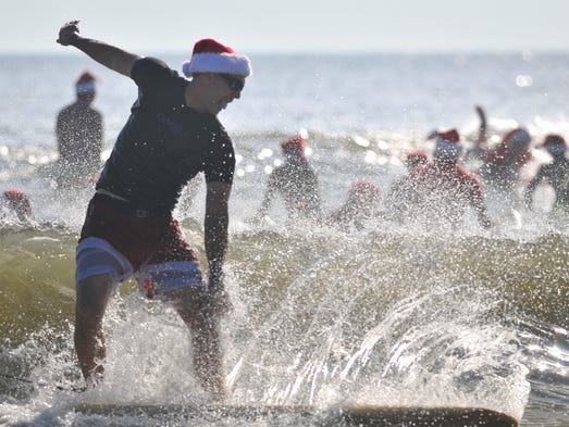 Thousands turned out to watch hundreds of surfing Santas
