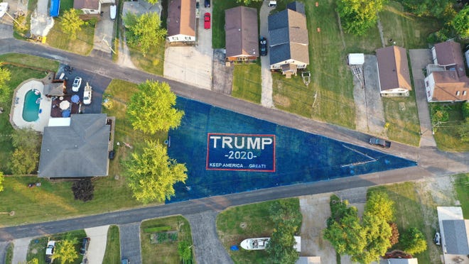 J.R. Majewski used about 120 gallons of biodegradable chalk paint to create a 19,000-square-foot Trump banner in his triangular front yard near Port Clinton. He said he wanted to show his appreciation of Trump's support for the military.
