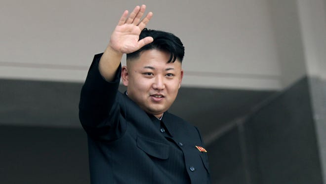 North Korea's leader Kim Jong Un waves to spectators at a mass military parade in July 2013.
