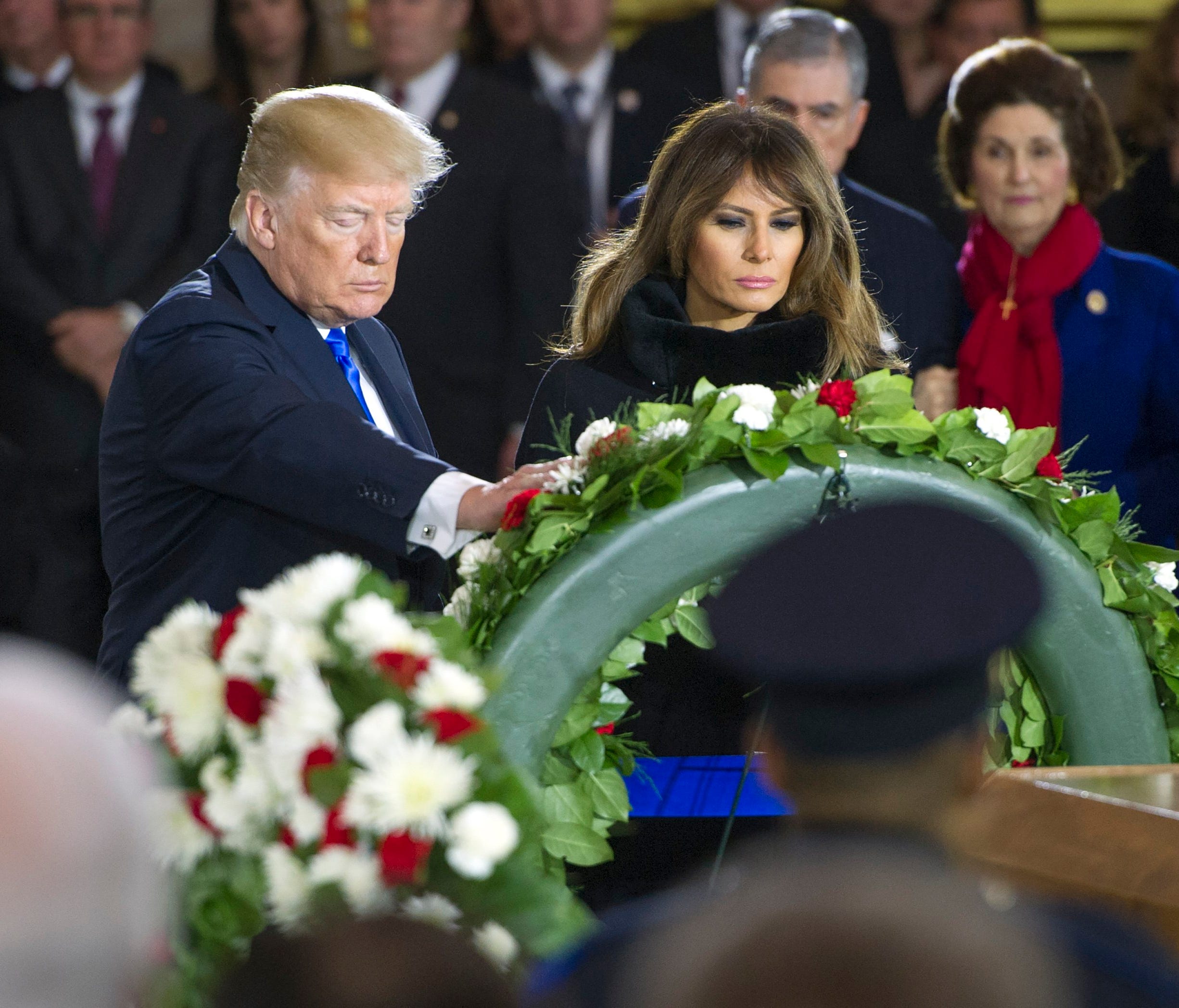 President Donald J. Trump and First Lady Melania Trump lay a wreath during a ceremony for American evangelist Billy Graham as he lies in honor in the Rotunda of the US Capitol in Washington, DC on Feb. 28, 2018.