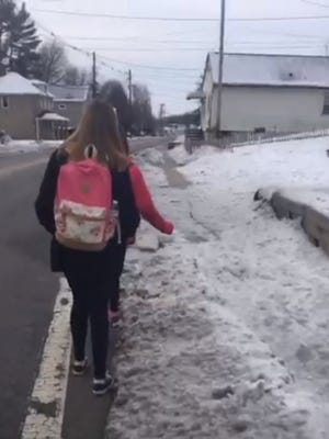 Wanaque schoolchildren walking on the street on Ringwood Ave. because of snow-covered sidewalks two days after the Sunday storm.