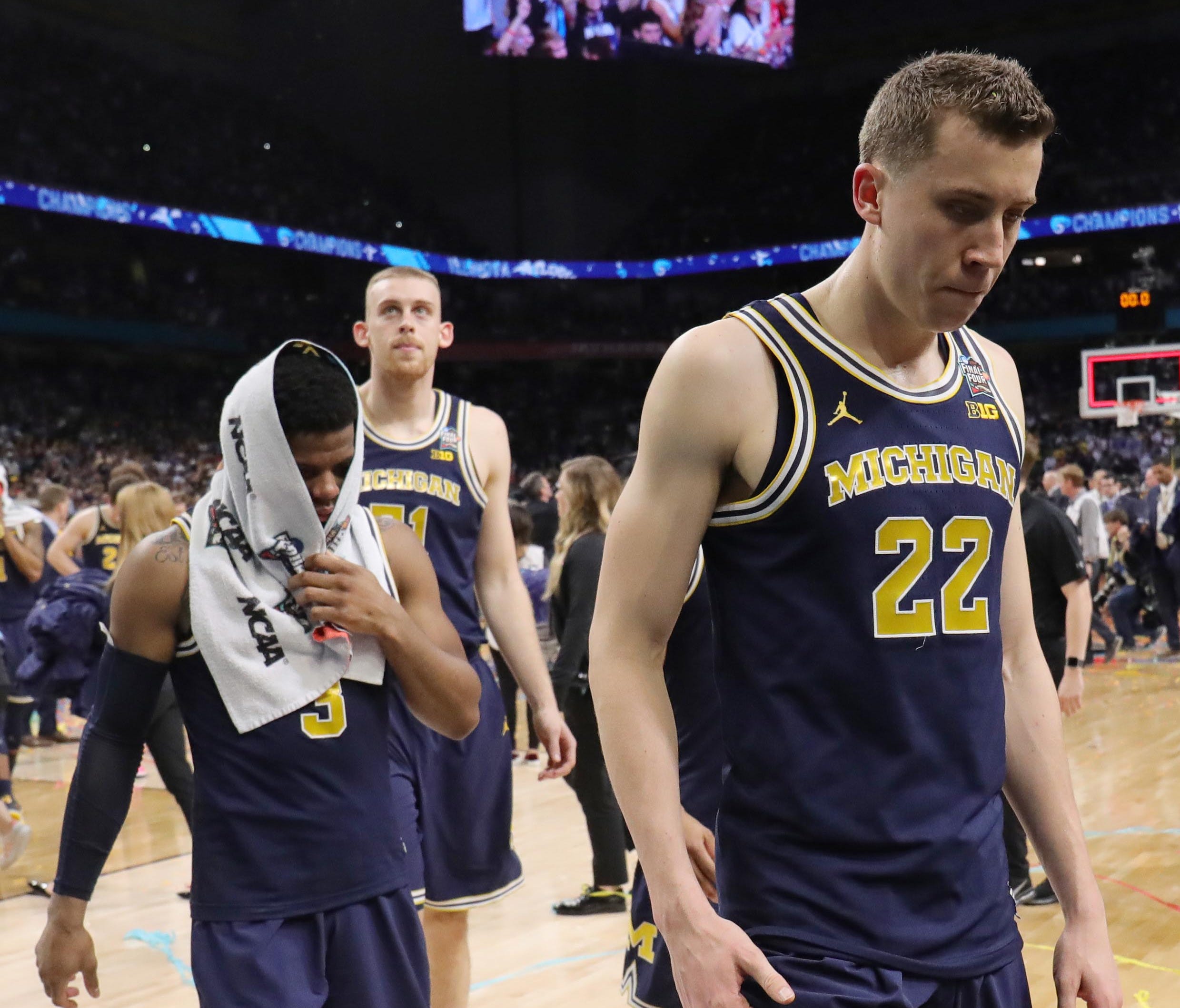 Michigan Wolverines guard Duncan Robinson (22) and guard Zavier Simpson (3) react as they leave the court after losing to the Villanova Wildcats in the championship game of the 2018 men's Final Four at Alamodome.