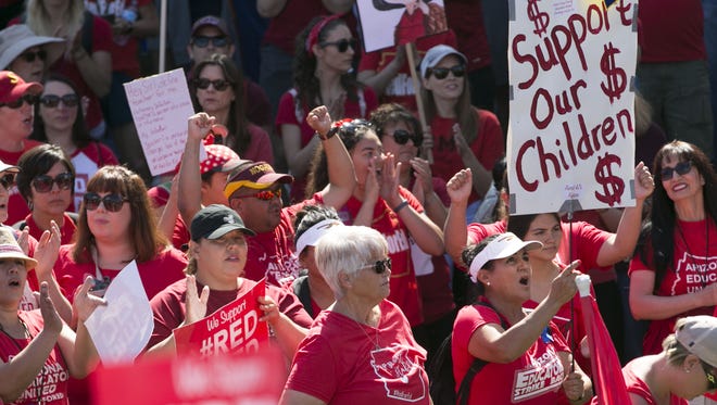 Teachers and other supporters rally during the sixth day of the Arizona teacher walkout at Wesley Bolin Memorial Plaza near the Arizona state Capitol in Phoenix on Thursday, May 3, 2018. Today will likely be the final day of the walkout as Governor Ducey signed an education funding bill into law early Thursday morning.
