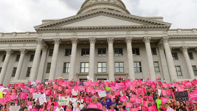 This Aug. 25, 2015, file photo, Karrie Galloway, CEO of Planned Parenthood Action Council, laughs as the roar of the crowd drowns out her speech at the state Capitol, in Salt Lake City.