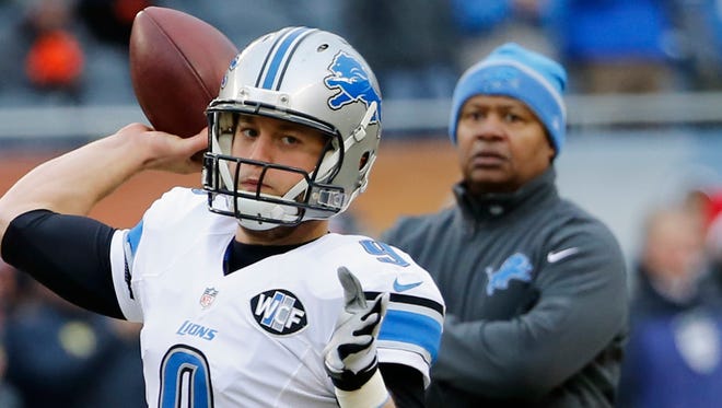 Lions quarterback Matthew Stafford warms up as coach Jim Caldwell watches before the game in Chicago in 2014.