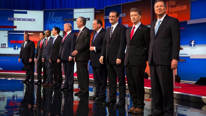 Republican presidential candidates from left, Chris Christie, Marco Rubio, Ben Carson, Scott Walker, Donald Trump, Jeb Bush, Mike Huckabee, Ted Cruz, Rand Paul, and John Kasich take the stage for the first Republican presidential debate at the Quicken Loans Arena Thursday, Aug. 6, 2015, in Cleveland.
