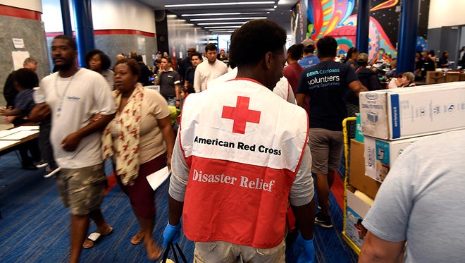 Red Cross volunteers move donated clothes and supplies through the George R. Brown Convention Center in Houston, TX on Thursday, August 31, 2017. The center acted as a shelter for those displaced during Hurricane Harvey, with about 6,000 people seeking refuge on Thursday.