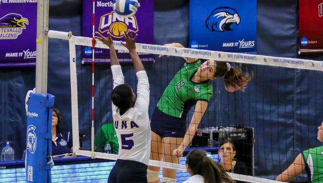 UWF's Rachel Neblett (13) smashes a shot past North Alabama's Ana Gabriela Pacheco (5) at the University of West Florida on Tuesday, October 10, 2017.  UWF, ranked #1 in the Gulf South Conference and #23 in the American Volleyball Coaches Association D-II poll, beat UNA, ranked #2 in the GSC, 3-2 to remain undefeated in conference play and extended its win streak to 13 in a row.