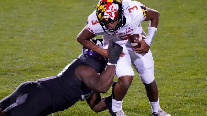 Maryland quarterback Taulia Tagovailoa is sacked by Northwestern defensive line Adetomiwa Adebawore during the second half of an NCAA college football game in Evanston, Ill., Saturday, Oct. 24, 2020. (AP Photo/Nam Y. Huh)