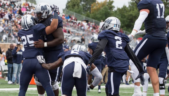 Monmouth, shown celebrating a touchdown in a win over Lafayette earlier this season, defeated Charleston Southern Saturday night, 23-20.