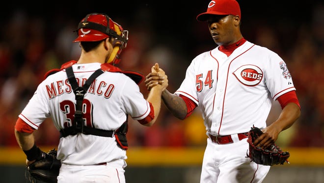 Reds relief pitcher Aroldis Chapman is congratulated Tuesday night by catcher Devin Mesoraco.