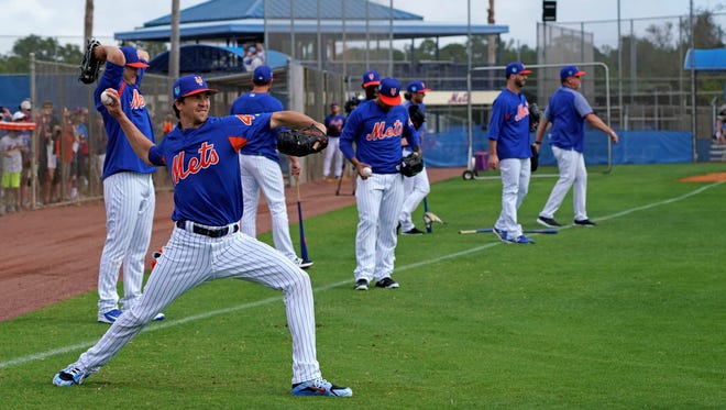 New York Mets starting pitcher Jacob deGrom warms up during a workout at First Data Field.
