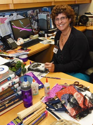 Angela Panzer, 59, a teen librarian at Adriance Memorial Library in the City of Poughkeepsie, pictured at her desk. 