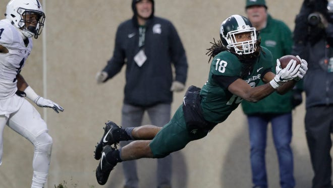 Michigan State wide receiver Felton Davis III, defended by Penn State cornerback Christian Campbell, catches a 33-yard touchdown pass Saturday.