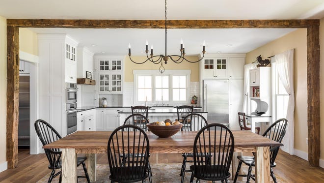 Beams from an old barn on the Zionsville property frame the kitchen/dining room.