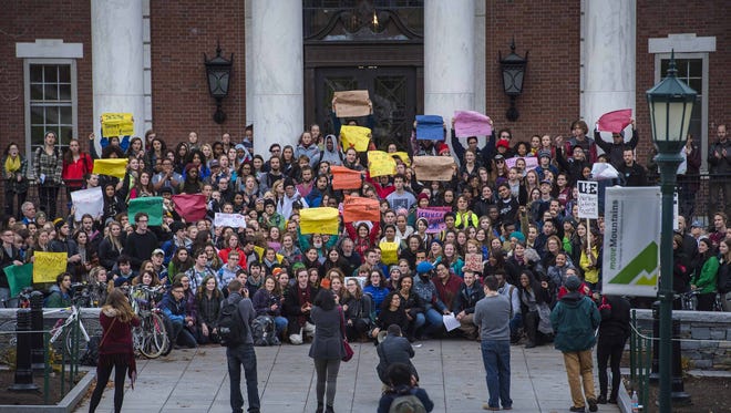 Protesters gather for a group photo at the Waterman Building at UVM in Burlington on Friday, after a demonstration in solidarity with the students at the University of Missouri, and to protest racism locally.