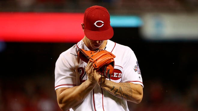Cincinnati Reds relief pitcher Michael Lorenzen (21) bends his glove in frustration as he leaves the mound after giving up the game-tying home run to Chicago Cubs first baseman Anthony Rizzo (44) in the top of the ninth inning.