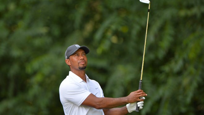 Tiger Woods hits his tee shot on the 12th hole during the second round of the Quicken Loans National golf tournament at Congressional Country Club - Blue Course.