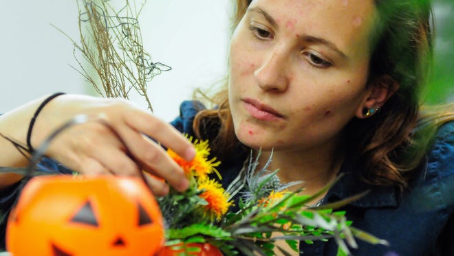 NMSU student Hannah Rheay, 21, designs a Halloween floral arrangement on Tuesday in Floral Design and Evaluation class. The NMSU floral team will be will be selling their Halloween arrangements on Oct. 28 at the Corbett Center on campus. The team also recently took home various honors at the Southern New Mexico State Fair; 13 students participated and 15 of their entries won ribbons including two merit awards, Best in Show and Second Best in Show.