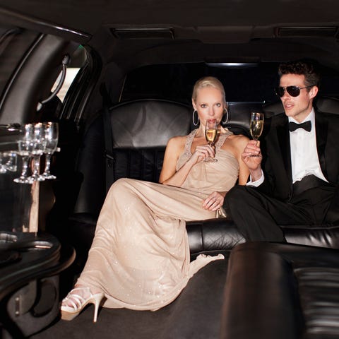 Couple drinking champagne in limo