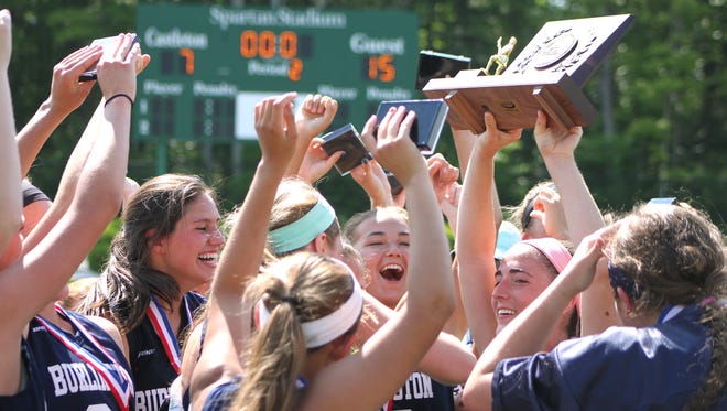 The Burlington High School girls lacrosse team celebrates its first state championship after beating Burr and Burton 15-7 in the Division I final on Saturday at Castleton State College. 