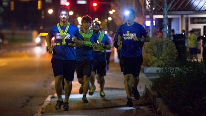 Richard Adams of Irondequoit and Jordan Meehl of Fairport leave Lost Borough Brewing Company for their weekly run down Atlantic Avenue with The Borough Runners on Thursday, Nov. 5.