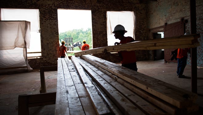 Triangle Construction workers undertake a major renovation of the Apalache Mill in Greer this summer to convert it into the Lofts by the Lake.