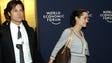 Brad Pitt and a visibly pregnant Angelina Jolie walk through the lobby at the World Economic Forum in Davos, Switzerland, on Jan. 26, 2006.