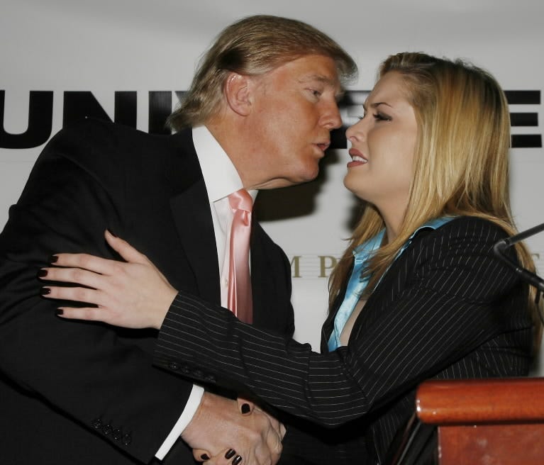 Donald Trump kisses Miss USA 2006 Tara Conner after a news conference in New York.