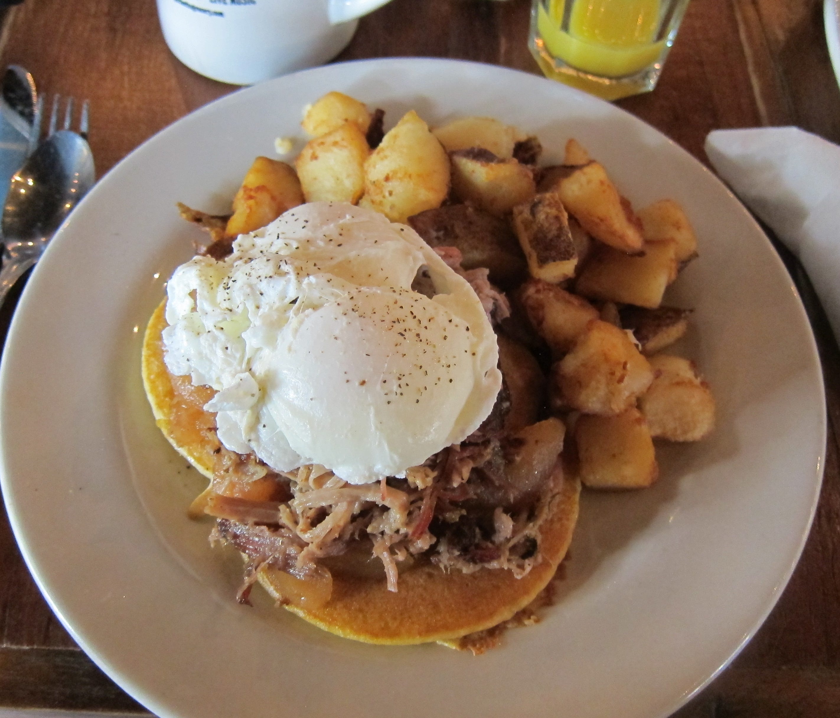 Puckett's Southern Stack is pulled pork over sweet potato pancakes with fried apples and an egg.