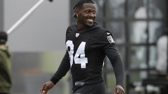 FILE - In this Aug. 20, 2019 file photo, Oakland Raiders' Antonio Brown smiles before stretching during NFL football practice in Alameda, Calif. Brown was released by the Raiders, Saturday, Sept. 7, 2019. (AP Photo/Jeff Chiu, File)