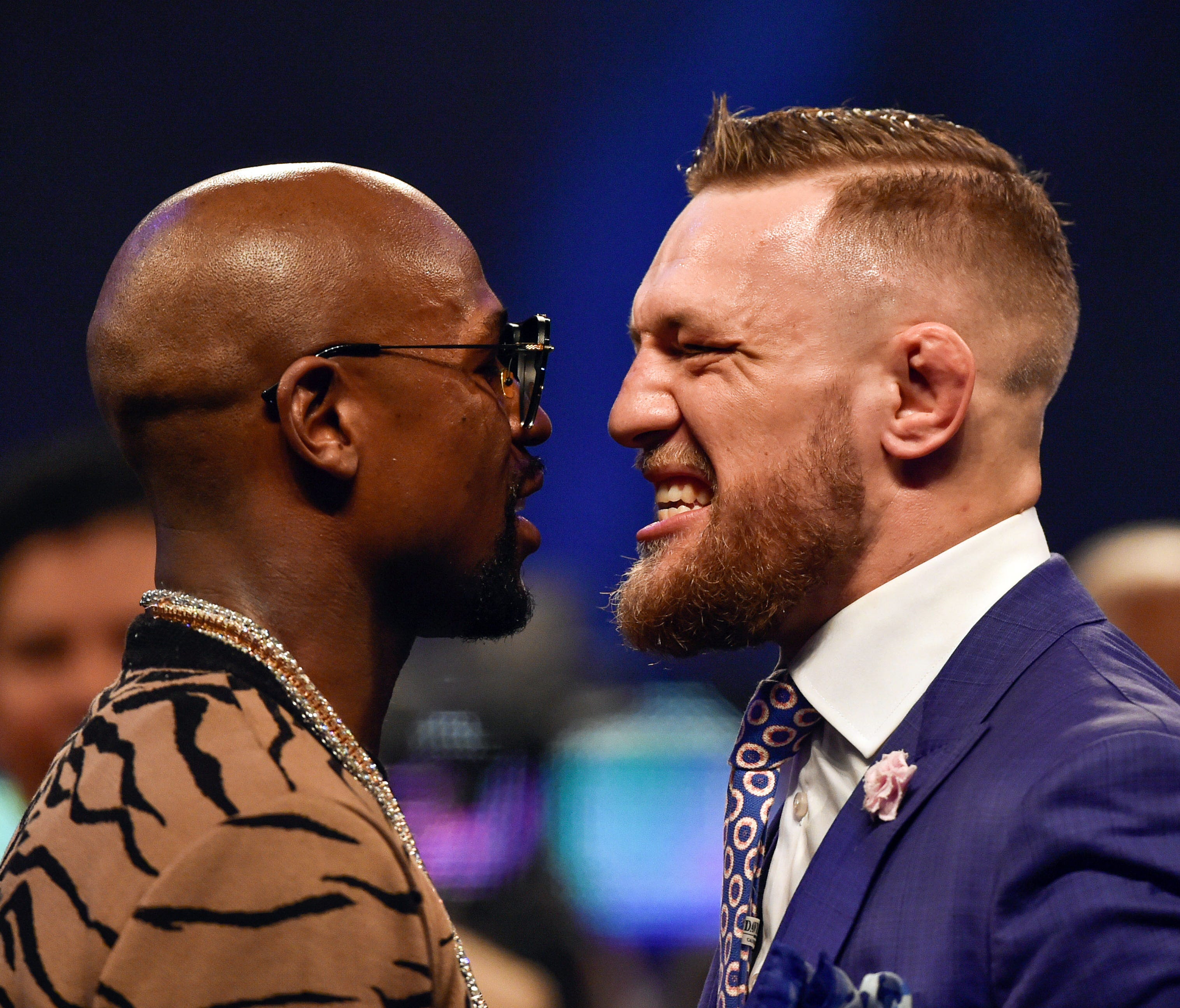 Floyd Mayweather, left, and Conor McGregor, right, face off during their world tour press conference to promote their Aug. 26 fight.