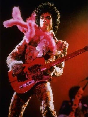 FILE - In this Jan. 11, 1985, file photo, Prince performs before a sold-out audience in Houston. Prince died at his his home on April 21, 2016. For Prince fans, the Friday, April 21, 2017, one-year anniversary of his shocking death from an accidental drug overdose will be a time for sadness and celebration. At his Paisley Park home and recording studio-turned-museum outside Minneapolis, four days of events are on tap, ranging from concert performances by his former bandmates to panel discussions on his legacy.