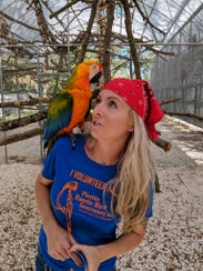Zsa Zsa, an 8-year-old Catalina Macaw, poses with Stephanie