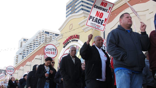 In this April 5, 2012 photo, union members picket outside the Tropicana casino in Atlantic City, N.J. Local 54 of the Unite-HERE union is threatening a strike against some of the Atlantic City casinos, including Tropicana, on July 1, 2016, if new contracts are not reached by then.