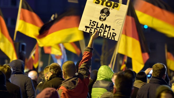 A Protester In Germany Holds A Banner Reading Stop Islam Terror A Protester In Germany Holds A Banner Reading Stop Islam Terror