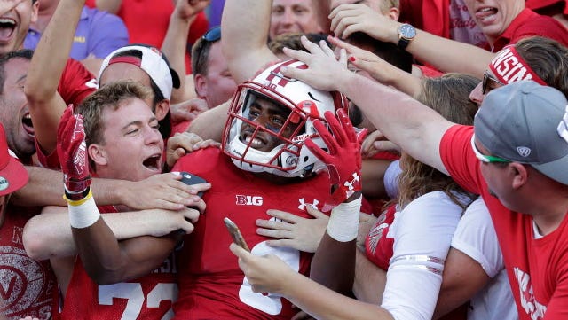 Wisconsin cornerback Sojourn Shelton celebrates the win against LSU by diving into the student section at Lambeau Field last season.