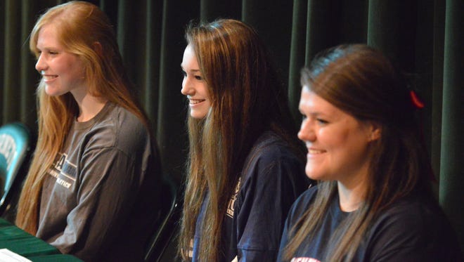 From left to right: Abby Taylor, Lexi Deffenbaugh and Jordan Sondrol had a ceremonial signing at Wilson Memorial on Thursday.