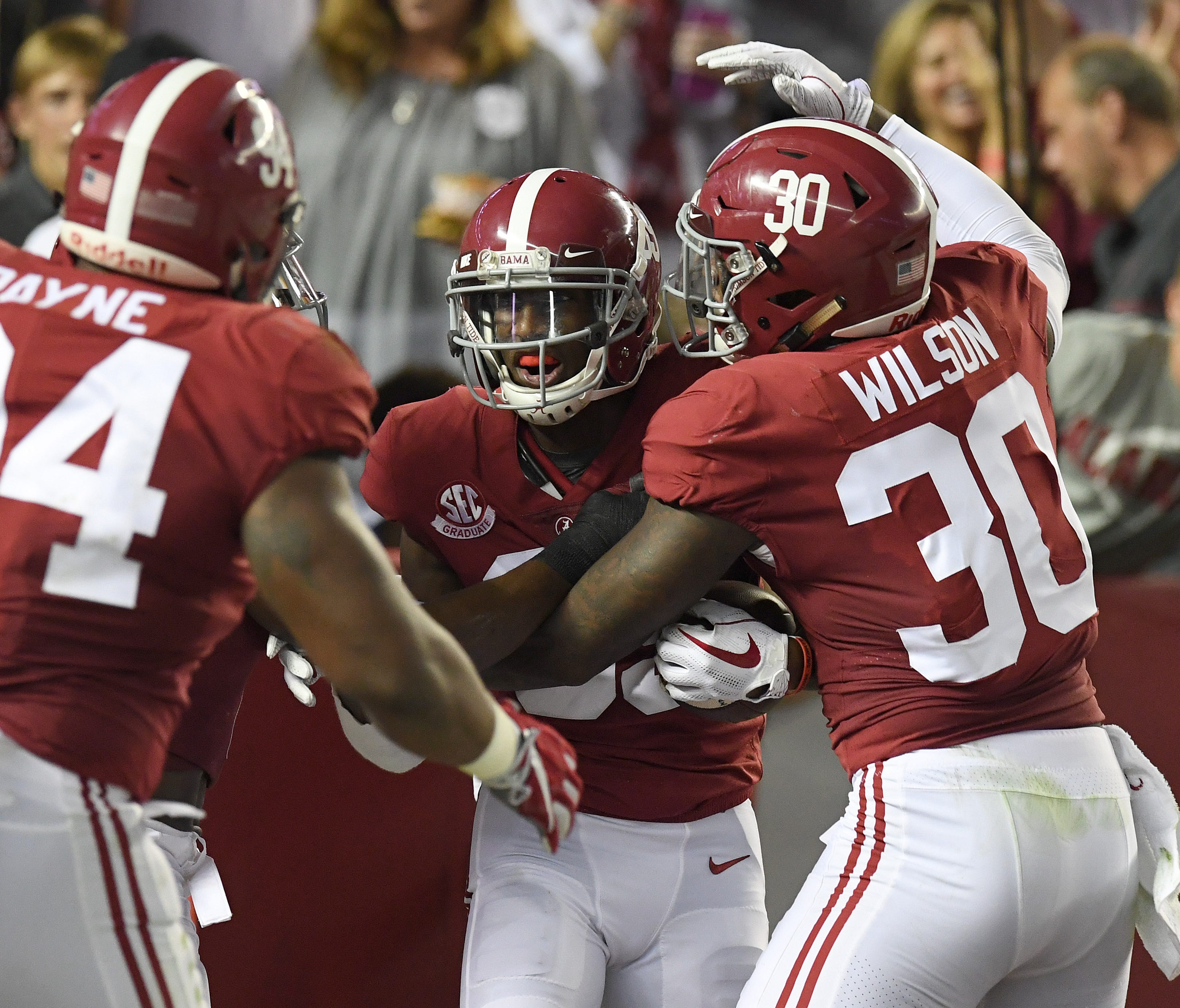 Alabama players celebrate after an interception for a touchdown against Mississippi.