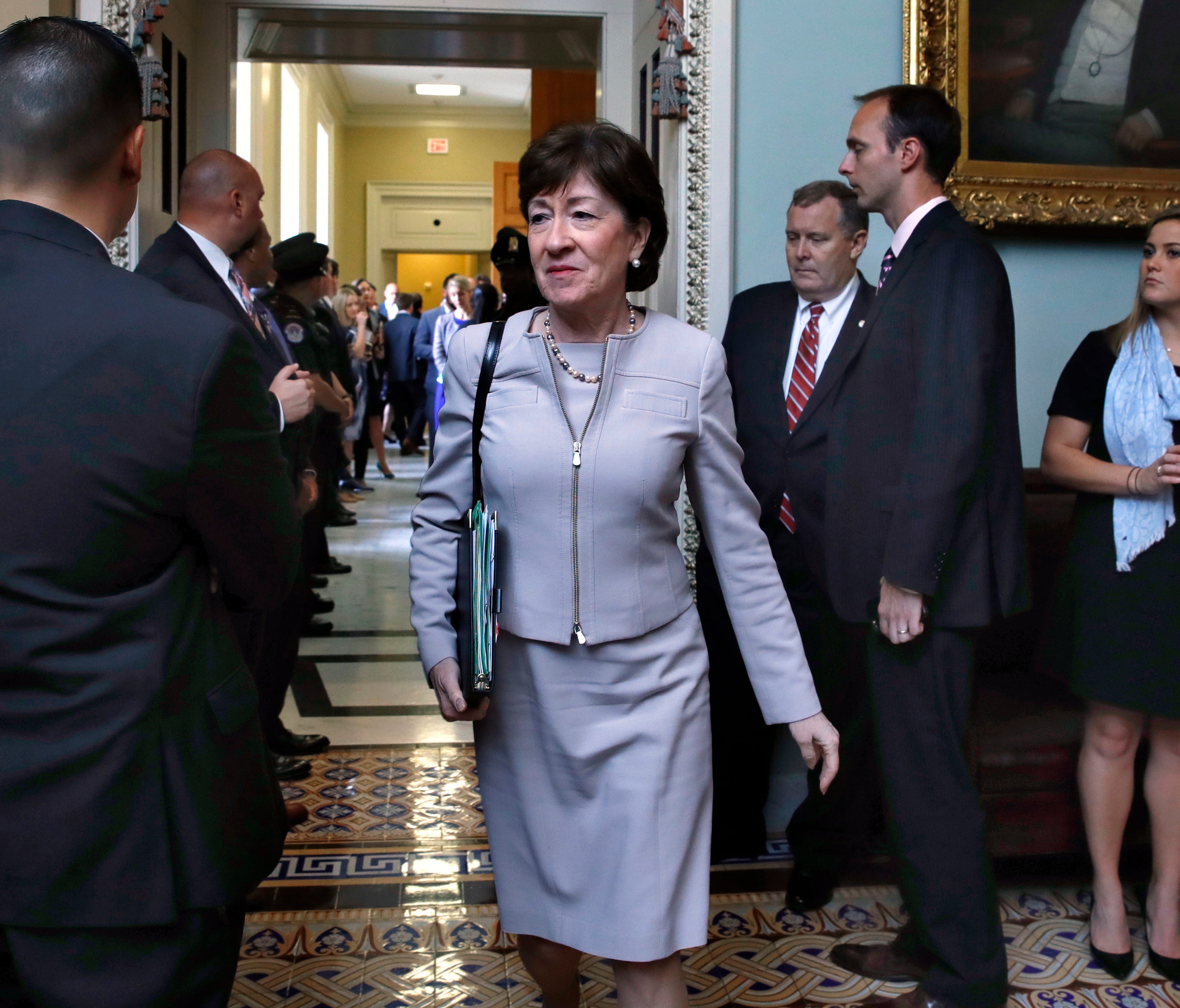 Sen. Susan Collins, R-Maine, center, leaves a meeting with Senate Republicans on Sept. 19, 2017, on Capitol Hill.